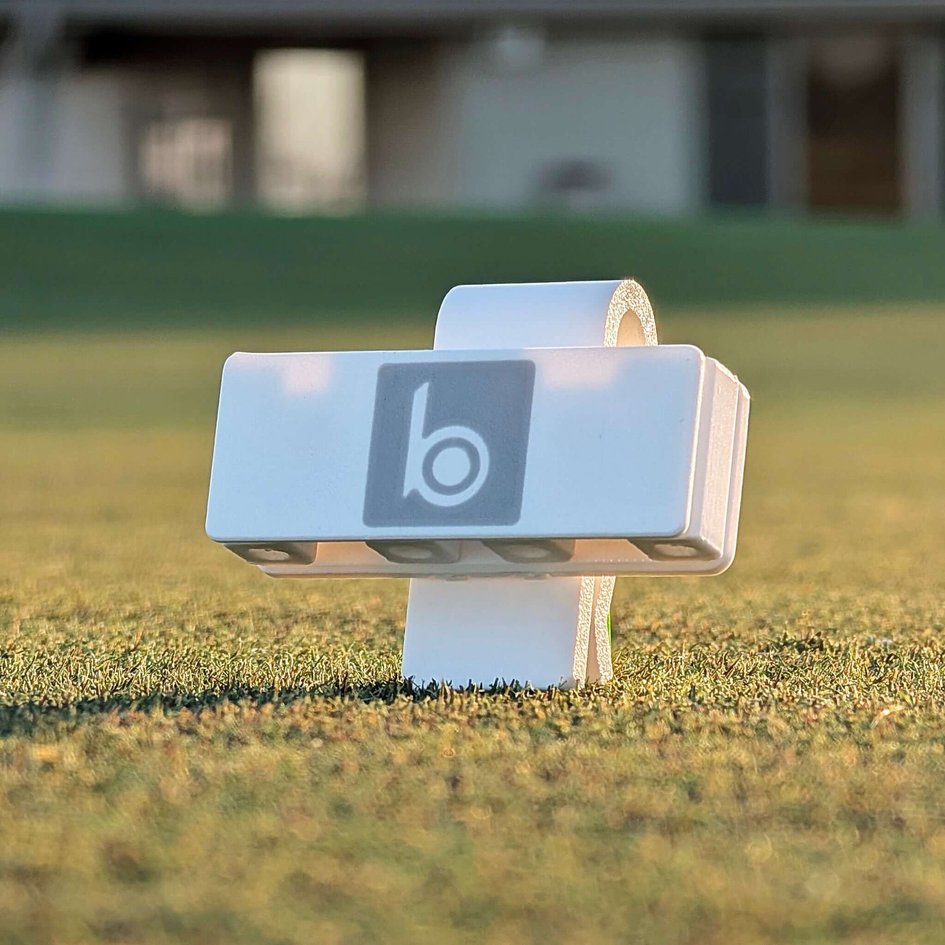 ProtoClip MINI 2 on a golf course, showcasing its compact design for easy tee access.