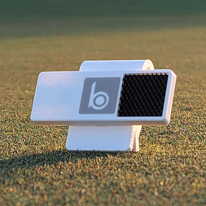 ProtoClip MINI 1: lightweight ball marker holder on golf course grass for easy access and organization.