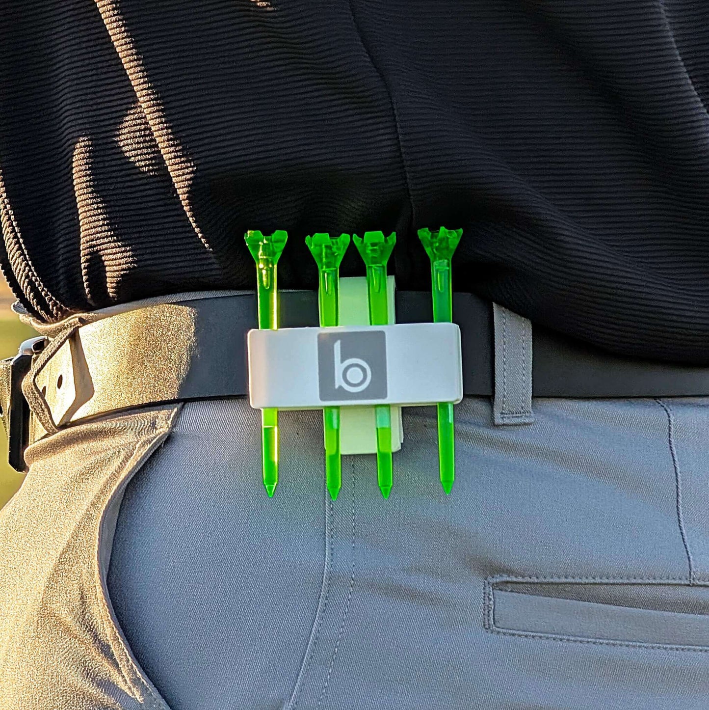 ProtoClip MINI 2 holding golf tees on a player's waistband, showcasing a compact and lightweight design for golfers.